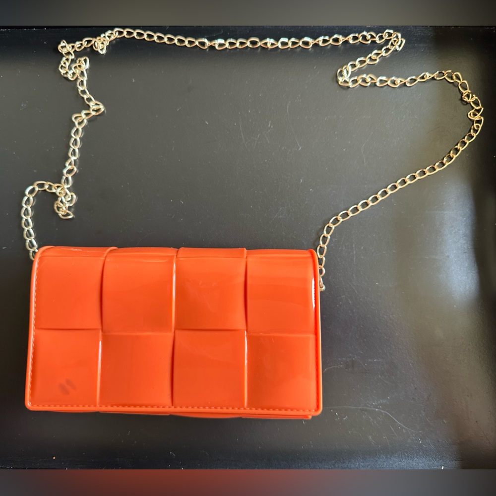 Orange Jelly clutch with gold cross body chain
